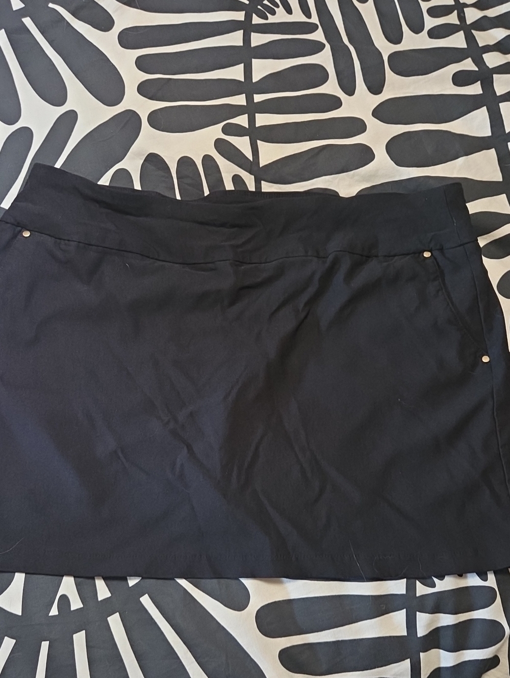 Attyre Black Golf Skirt with Subtle Rivet Detail, Pockets And Shorts Inside